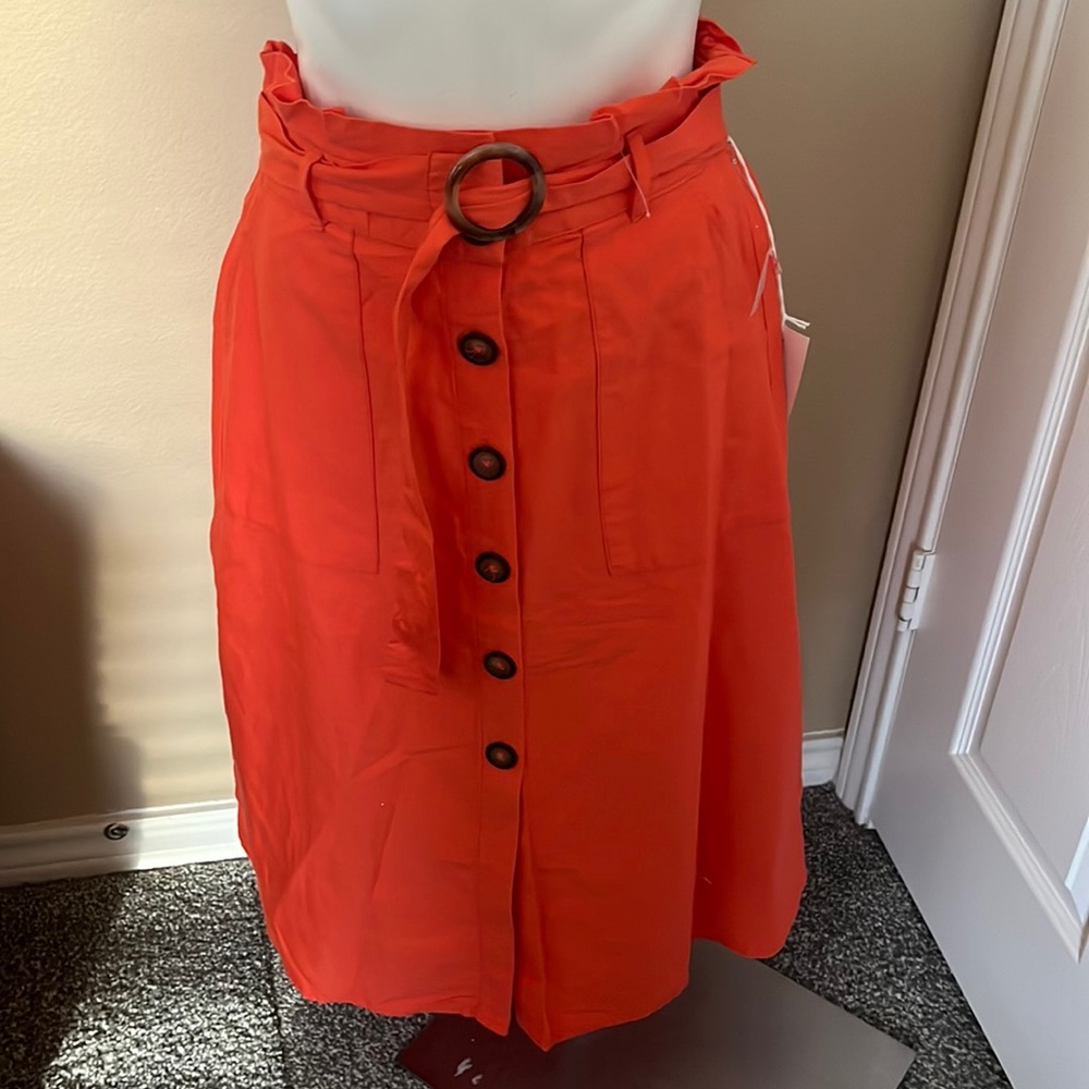 Long melon color skirt with buttons down the middle size M